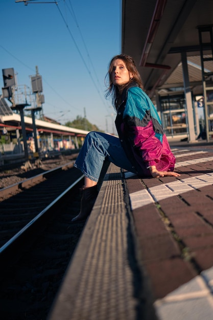 Foto hermosa chica caucásica posando en el andén del ferrocarril