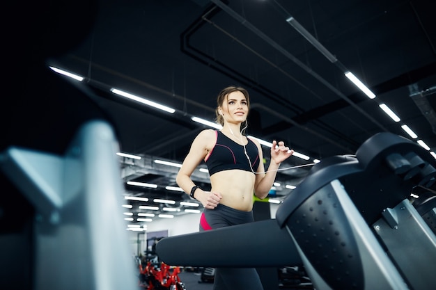 Hermosa chica en forma posando en el gimnasio