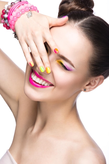 Hermosa chica con gafas de sol rosas con maquillaje brillante y uñas coloridas Cara de belleza Fotografía tomada en el estudio sobre un fondo blanco