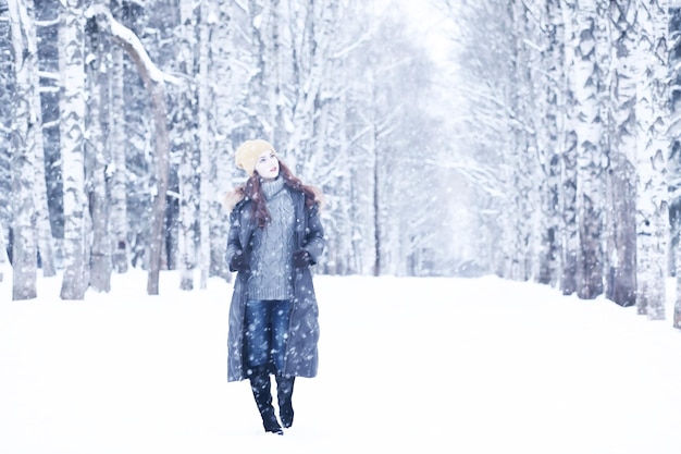 Hermosa chica en un hermoso día en el parque de nieve de invierno