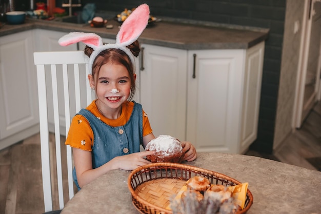 Hermosa chica en orejas de conejo pinta huevos de Pascua