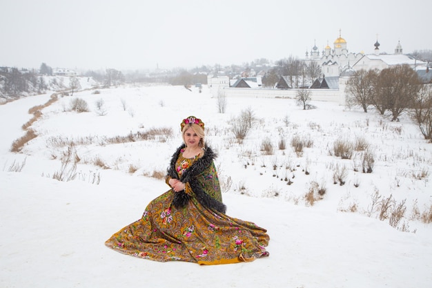 Hermosa chica rusa en un vestido nacional de invierno
