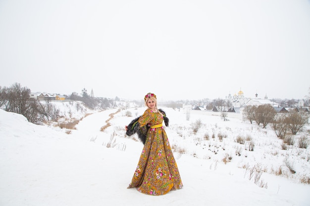 Hermosa chica rusa en un vestido nacional de invierno