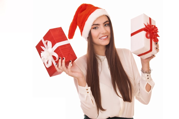 Hermosa chica con sombrero de navidad y con dos cajas de regalo en la mano