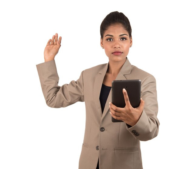 Hermosa chica sosteniendo y presentando algo en la mano con teléfono inteligente o tableta