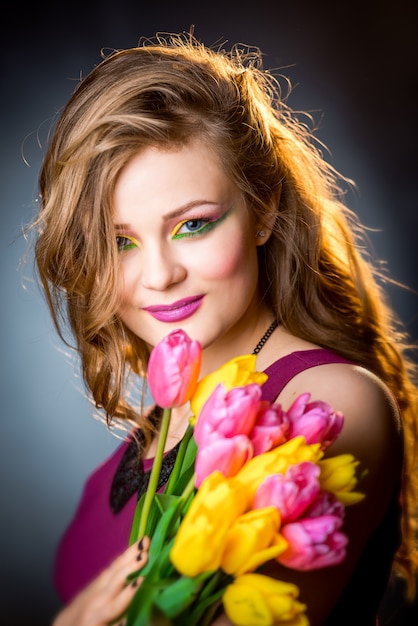 Hermosa chica con tulipanes flores