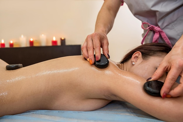 Hermosa joven acudió a un especialista profesional para un masaje de bienestar en el salón El concepto de un masaje profesional saludable