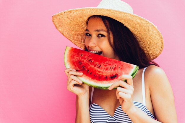 Hermosa joven asiática con bikini. Retratos sobre fondos coloreados