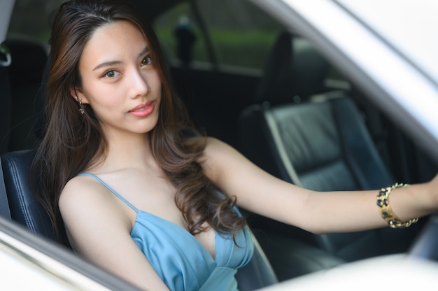 Foto hermosa joven conduciendo un coche