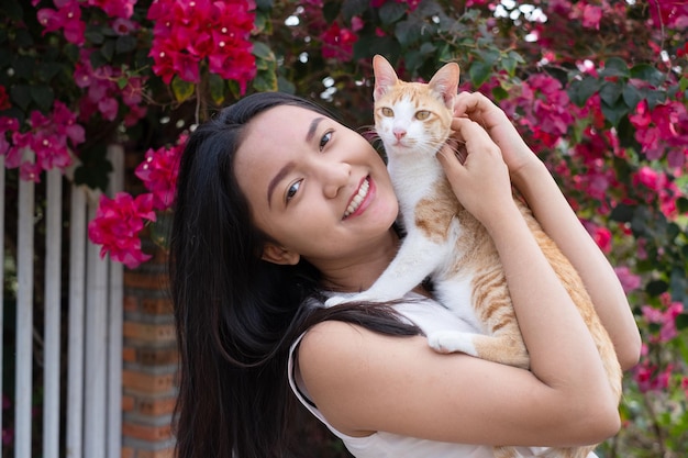 Hermosa joven con un gato afuera