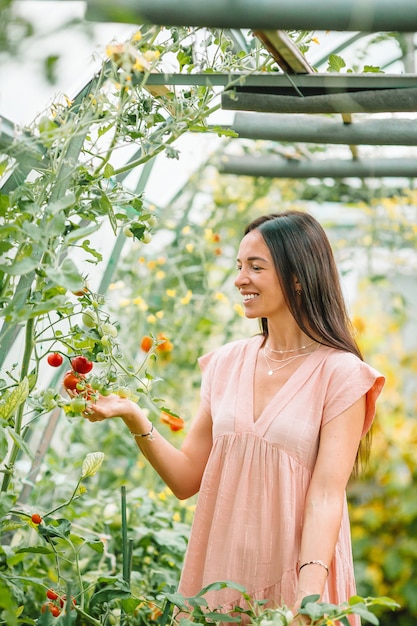 Hermosa joven jardinería en invernadero