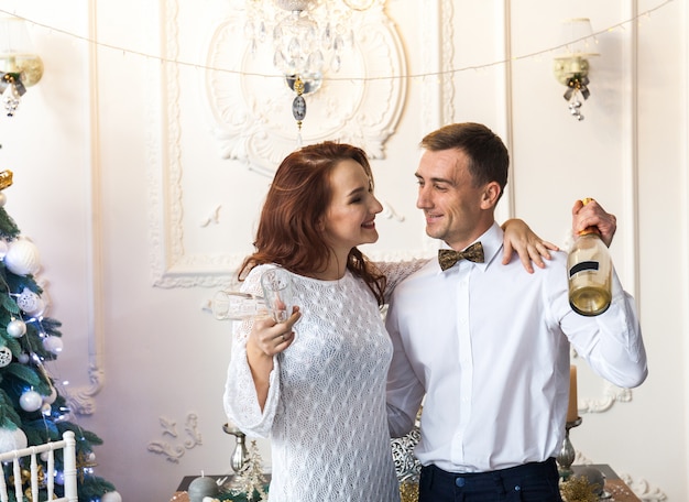 Hermosa joven pareja celebrando la Navidad en casa