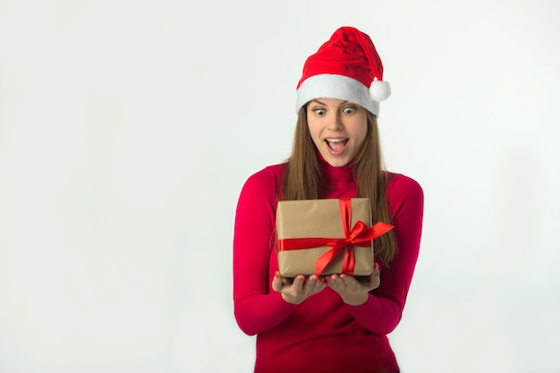 hermosa joven con sombrero de santa claus con un regalo