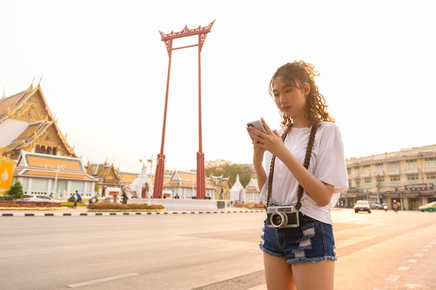 Hermosa joven turista asiática de vacaciones haciendo turismo y explorando Bangkok