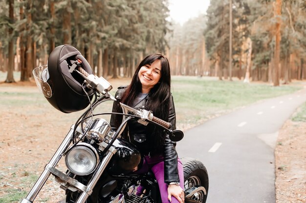 La hermosa morena en moto en el parque