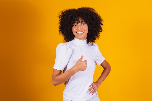 Hermosa mujer afro con el pulgar hacia arriba. Mujer haciendo señal de ok.