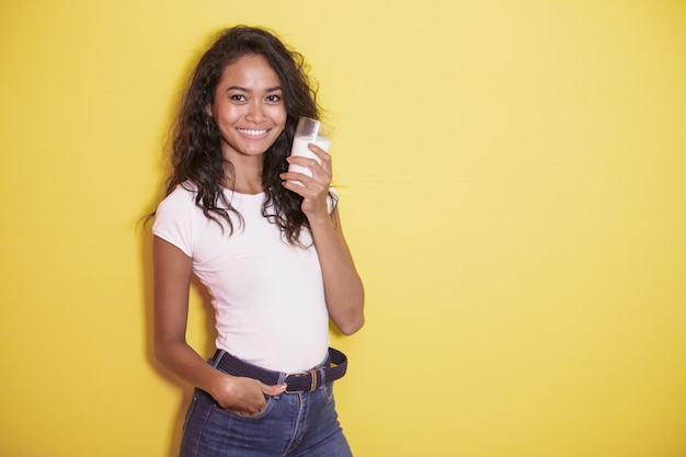 Hermosa mujer asiática con un vaso de leche fresca