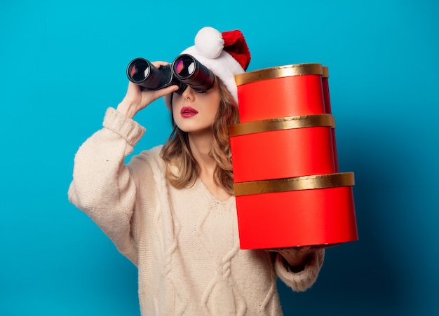 Hermosa mujer con caja de regalo y binoculares