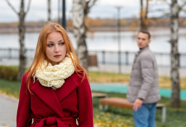 Hermosa mujer camina en el parque, el joven la mira