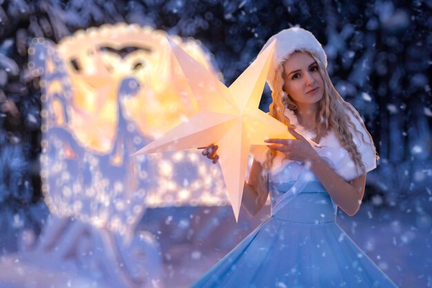 Foto hermosa mujer como doncella de nieve con trineo y estrellas.