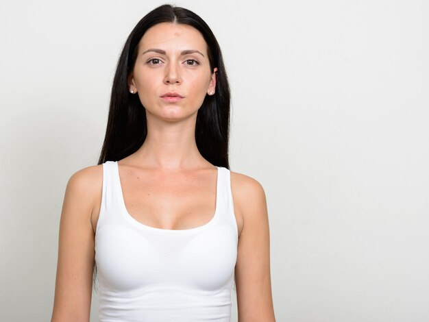 Foto hermosa mujer contra la pared blanca