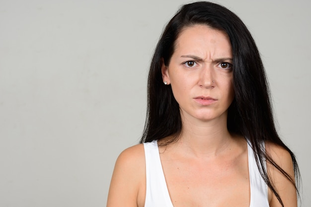 Foto hermosa mujer contra la pared blanca