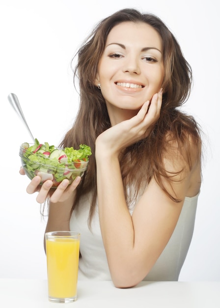Una hermosa mujer esbelta comiendo comida saludable