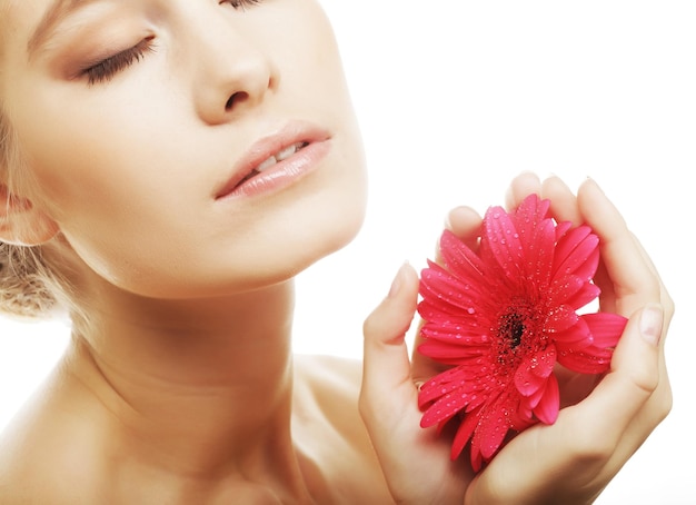 Hermosa mujer joven con flor de gerber