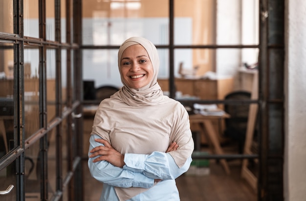 Hermosa mujer joven con hijab trabajando en la oficina