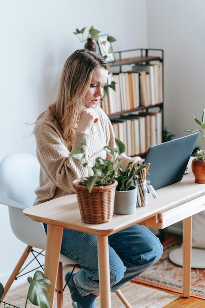 Hermosa mujer joven trabajando usando una computadora portátil concentrada