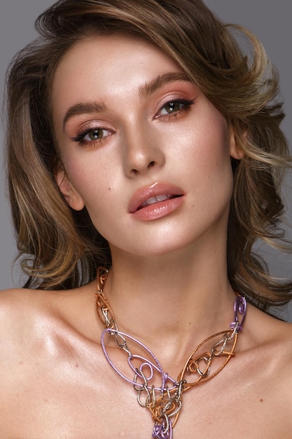 Hermosa mujer con maquillaje desnudo clásico peinado ligero Rostro de belleza Foto tomada en estudio
