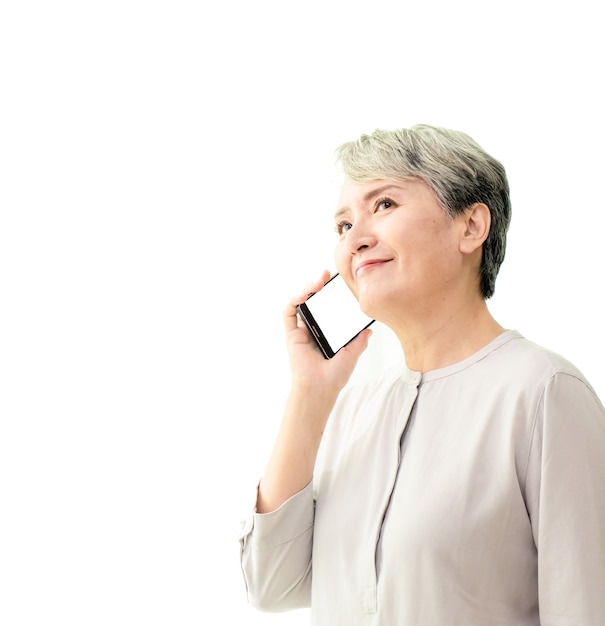 Hermosa mujer mayor hablando por teléfono inteligente y sonriendo