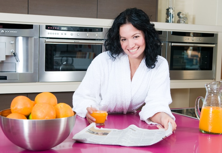 Foto hermosa mujer morena desayunando en su cocina