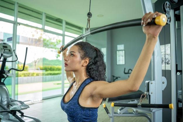 Hermosa mujer musculosa en forma ejercitando músculos de construcción