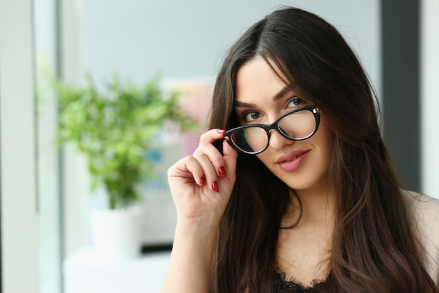 Hermosa mujer de negocios de moda sonriente tiene gafas de cerca