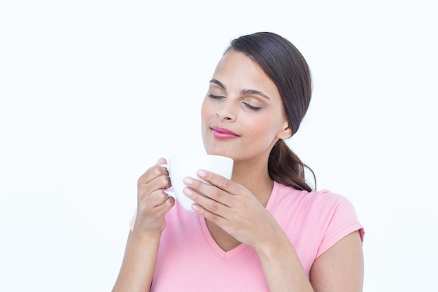 Hermosa mujer oliendo su café