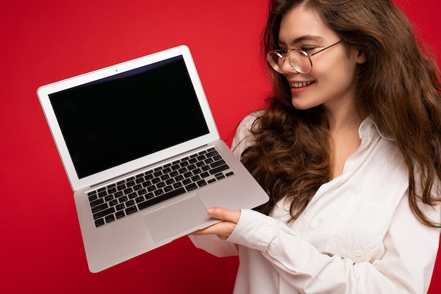 Hermosa mujer sosteniendo computadora portátil