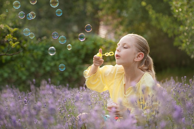 Hermosa niña en un campo con lavanda