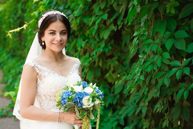 Hermosa novia al aire libre en un bosque.