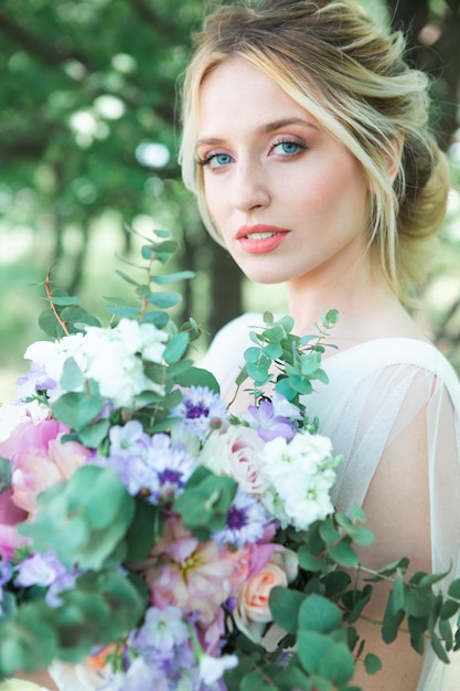 Hermosa novia emocional en la naturaleza con plantas