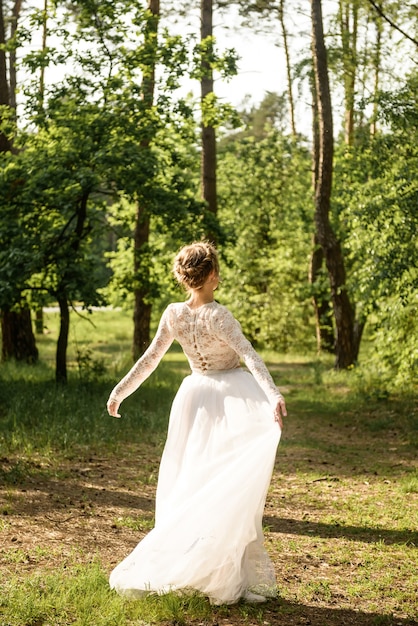 Hermosa novia posando para la cámara en un bosque