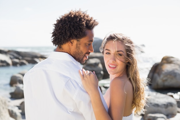 Hermosa pareja abrazándose en la costa