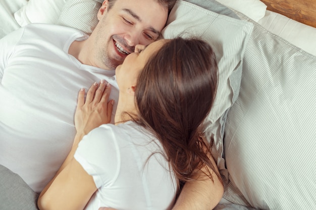 Hermosa pareja acostada en la cama