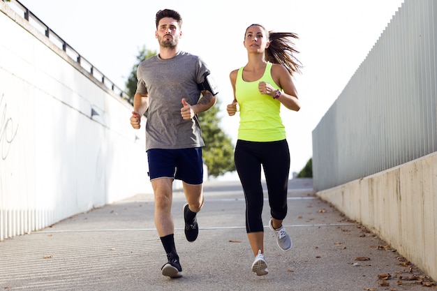 Foto hermosa pareja corriendo en la calle.