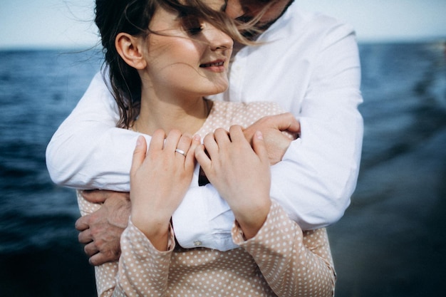 Hermosa pareja enamorada en una playa del lago