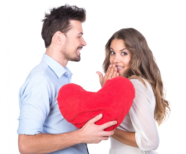 Hermosa pareja de enamorados con almohada de corazón.