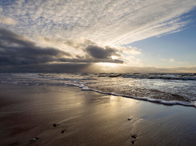 Hermosa puesta de sol de invierno en la playa de arena del Mar Báltico en Lituania Klaipeda