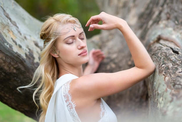 Hermosa rubia con un vestido blanco con un elegante peinado de cerca