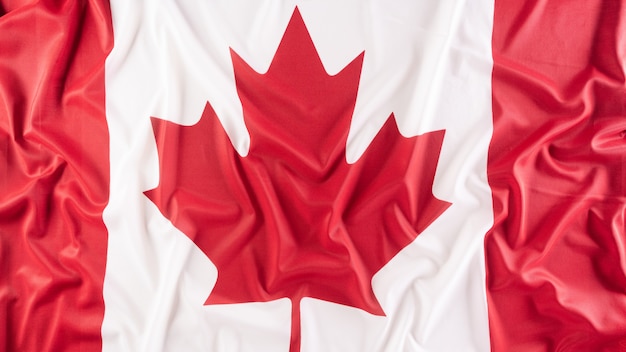Una hermosa tela de tela de la bandera nacional de Canadá, un signo o símbolo del concepto del día de Canadá