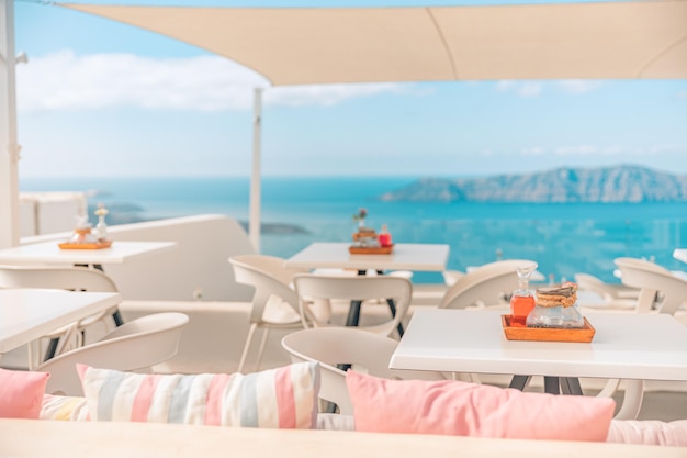 Hermosa terraza con mesa y sillas modernas en el restaurante al aire libre Thira, isla de Santorini, Grecia